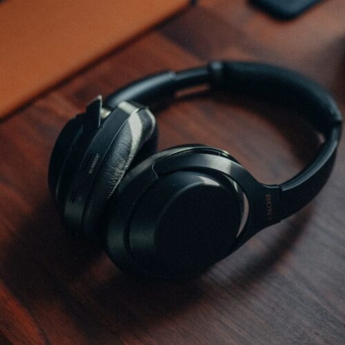 a pair of headphones sitting on top of a wooden desk
