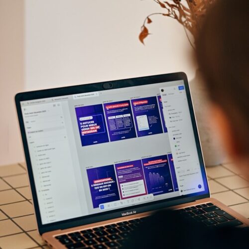 Person looking at a laptop screen with presentation slides.