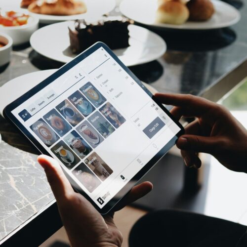 A person sitting at a table with a tablet